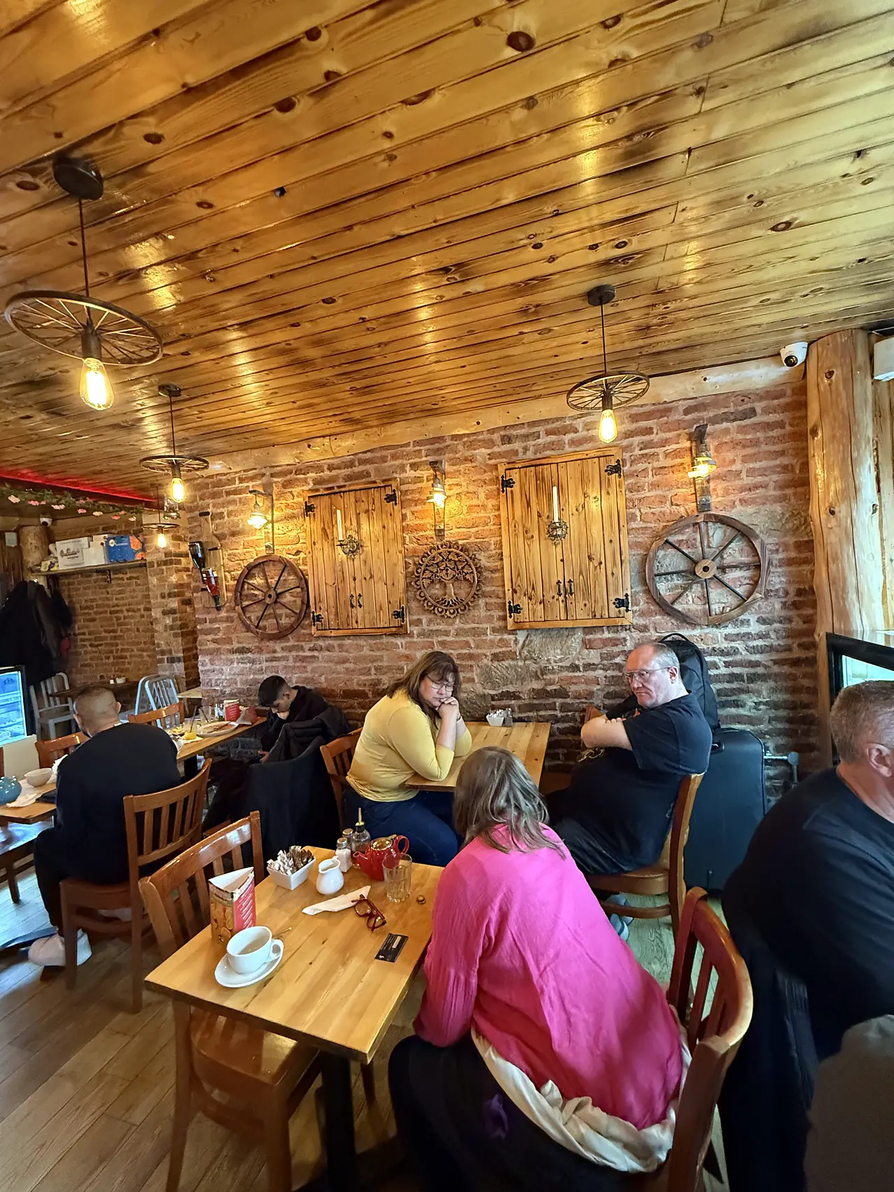 Dining room with wagon wheels on the brick wall